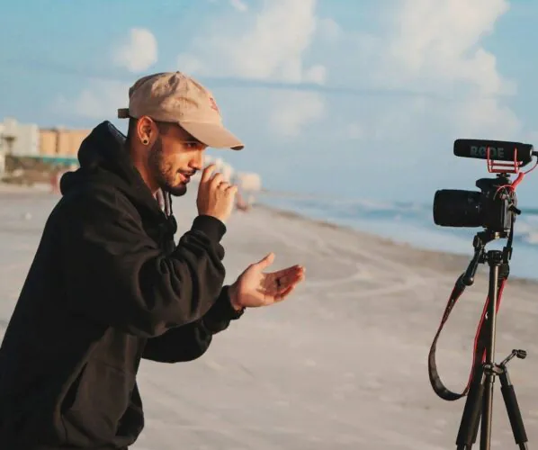man in black jacket holding camera during daytime