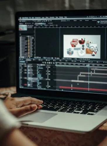 person using macbook pro on table